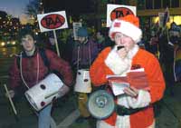 [PICTURE -Mike Quieto leads the singing of labor carols ]